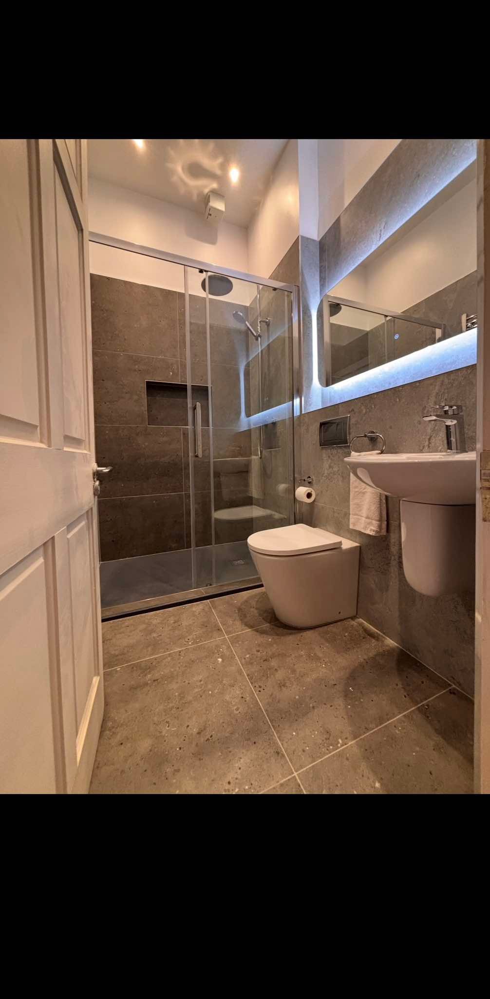Luxury bathroom installation with walk-in shower and LED mirror, completed by The Pipe Guy, Kildare